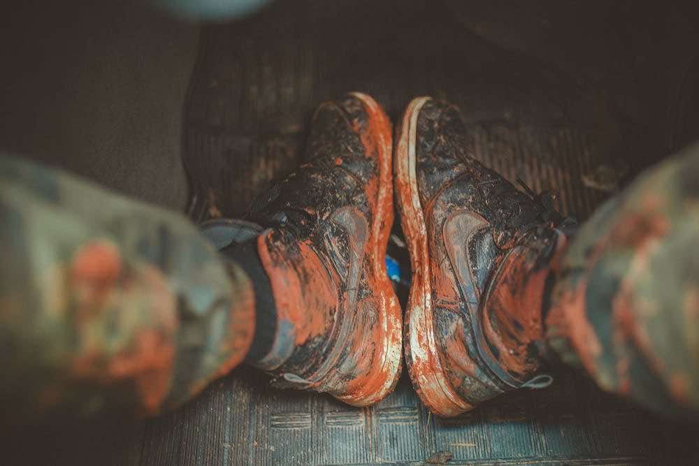 Shoes soaked in a lot of brown paint