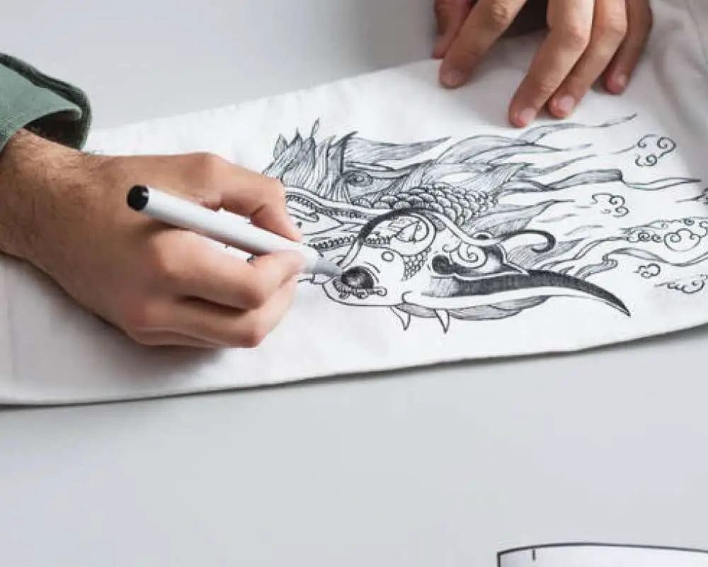 A person creating a drawing with pen