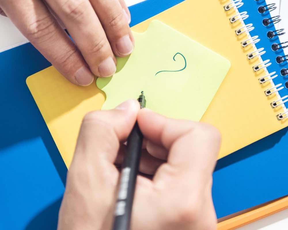 A person drawing with fine tip pen