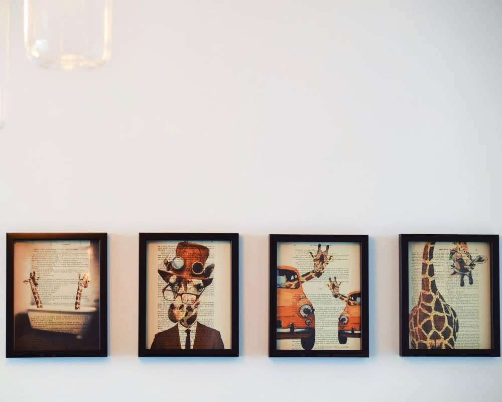 Four framed paintings on a wall