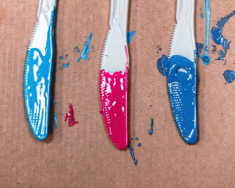 Three knives with acrylic paint on them
