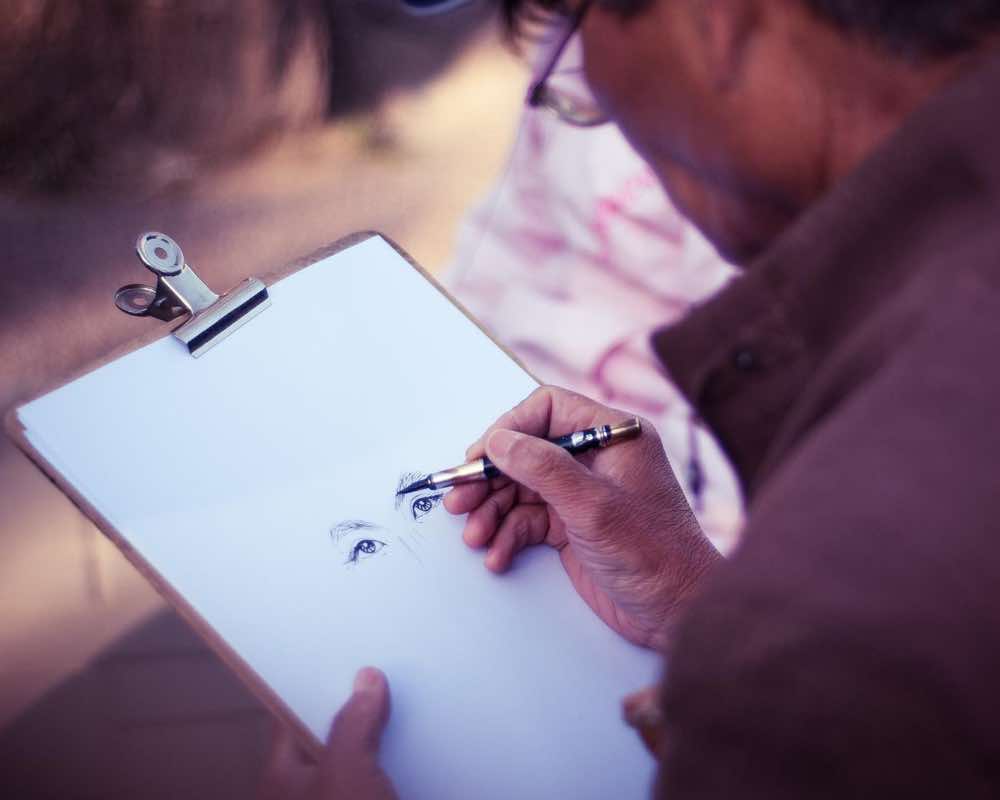 A man making a pen drawing