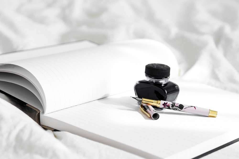 An ink pot, fountain pen and a journal