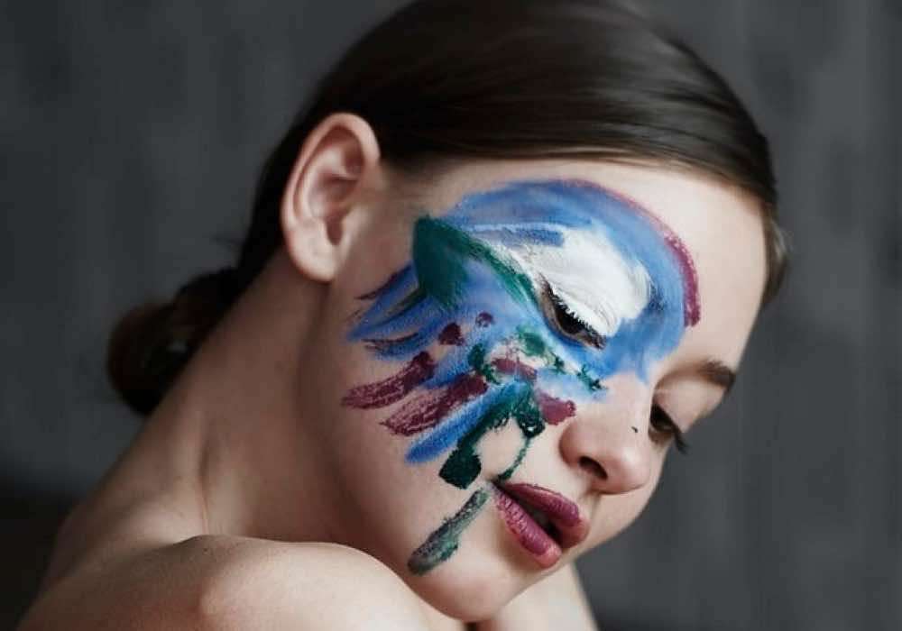 A lady with half face painted