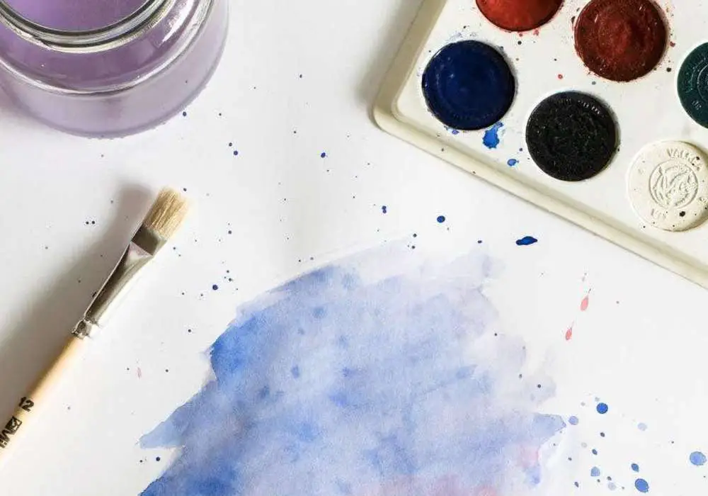 A blended wash of blue and red watercolor paint