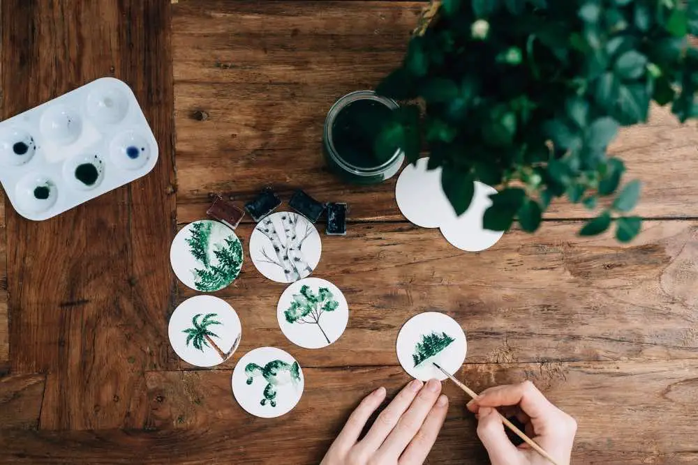 Tiny trees painted in watercolor on small circular sheets