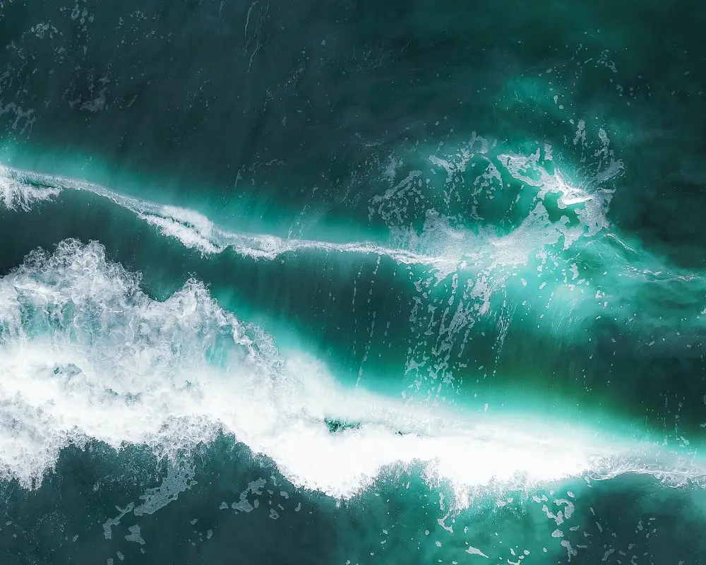 The blue-green waves of an ocean from aerial perspective