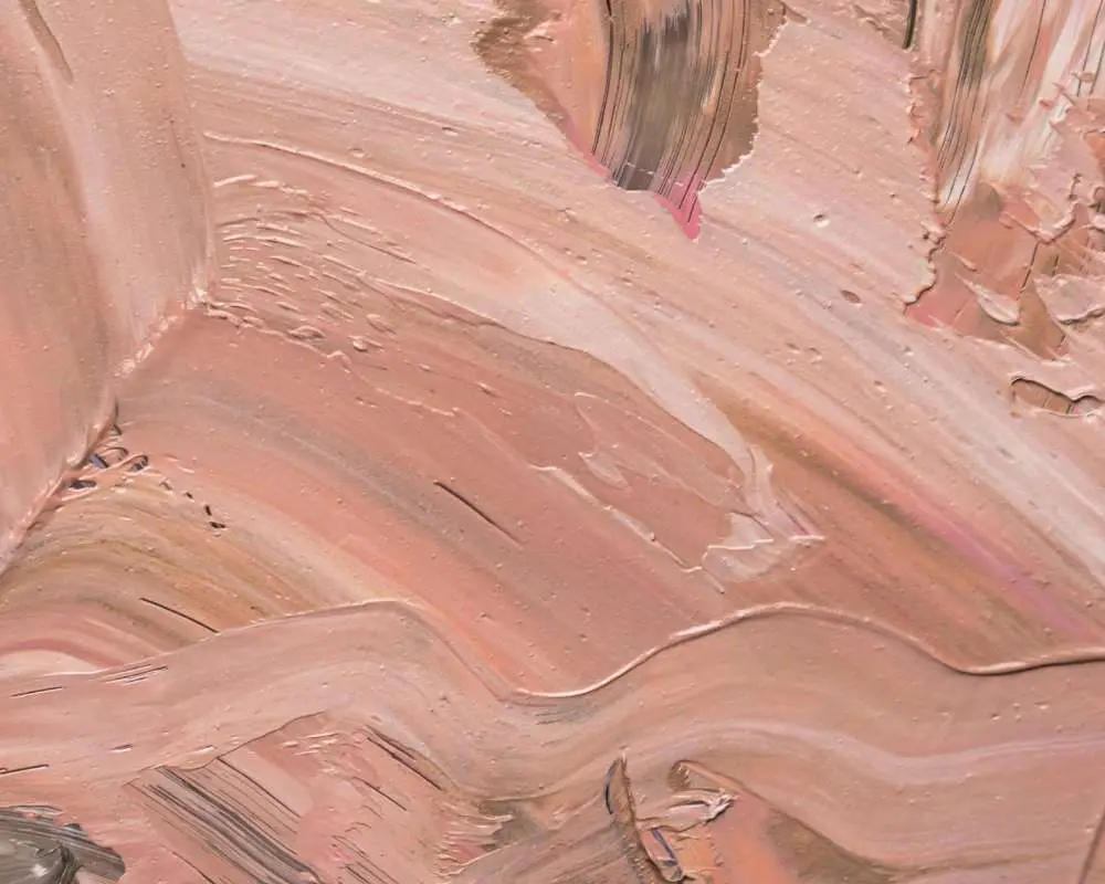 A painted texture of peach along with slight strokes of brown and pink
